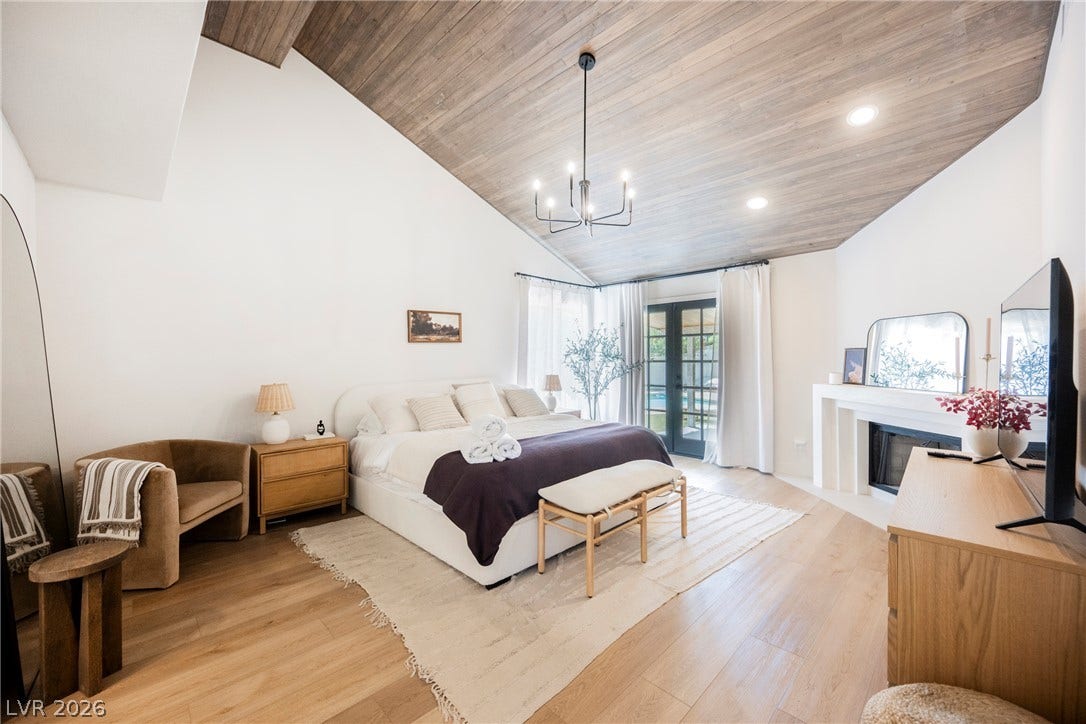 5741 S Pearl Street, Las Vegas, NV 89120 A vaulted wood ceiling and warm hardwood floors elevate this master bedroom retreat.