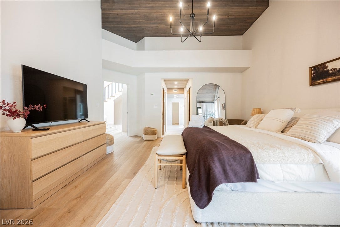 5741 S Pearl Street, Las Vegas, NV 89120 Rich wood plank ceilings and warm hardwood floors elevate this airy primary suite.