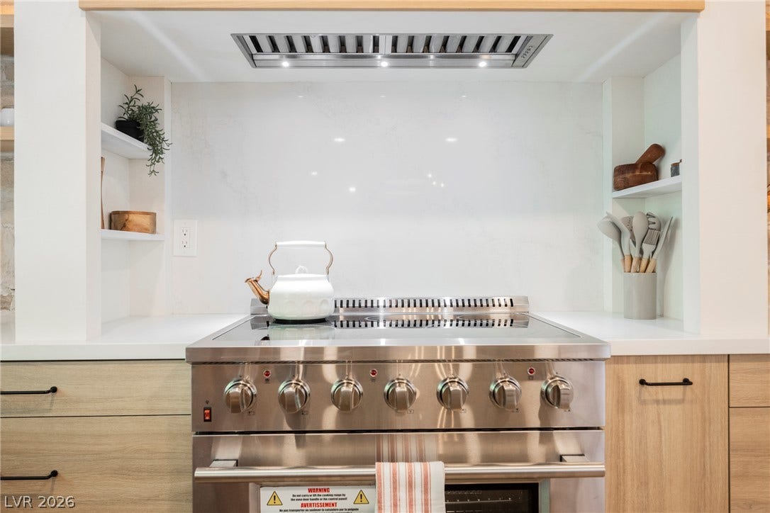 5741 S Pearl Street, Las Vegas, NV 89120 A professional-grade stainless steel range anchors this sleek cooking alcove.
