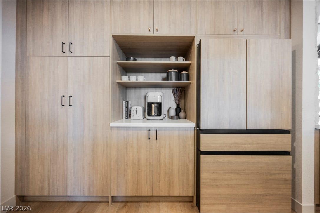 5741 S Pearl Street, Las Vegas, NV 89120 Custom wood cabinetry integrates seamlessly with the flooring for a streamlined, modern aesthetic.