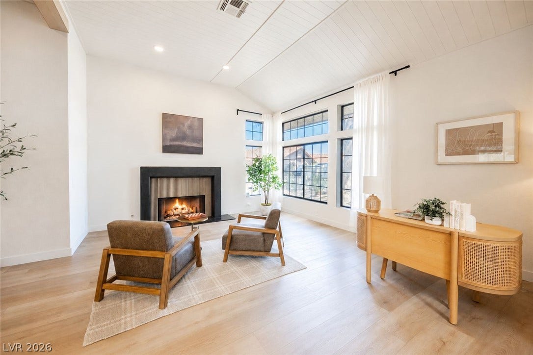 5741 S Pearl Street, Las Vegas, NV 89120 Soaring vaulted ceilings and a sleek modern fireplace define this light-filled living space.