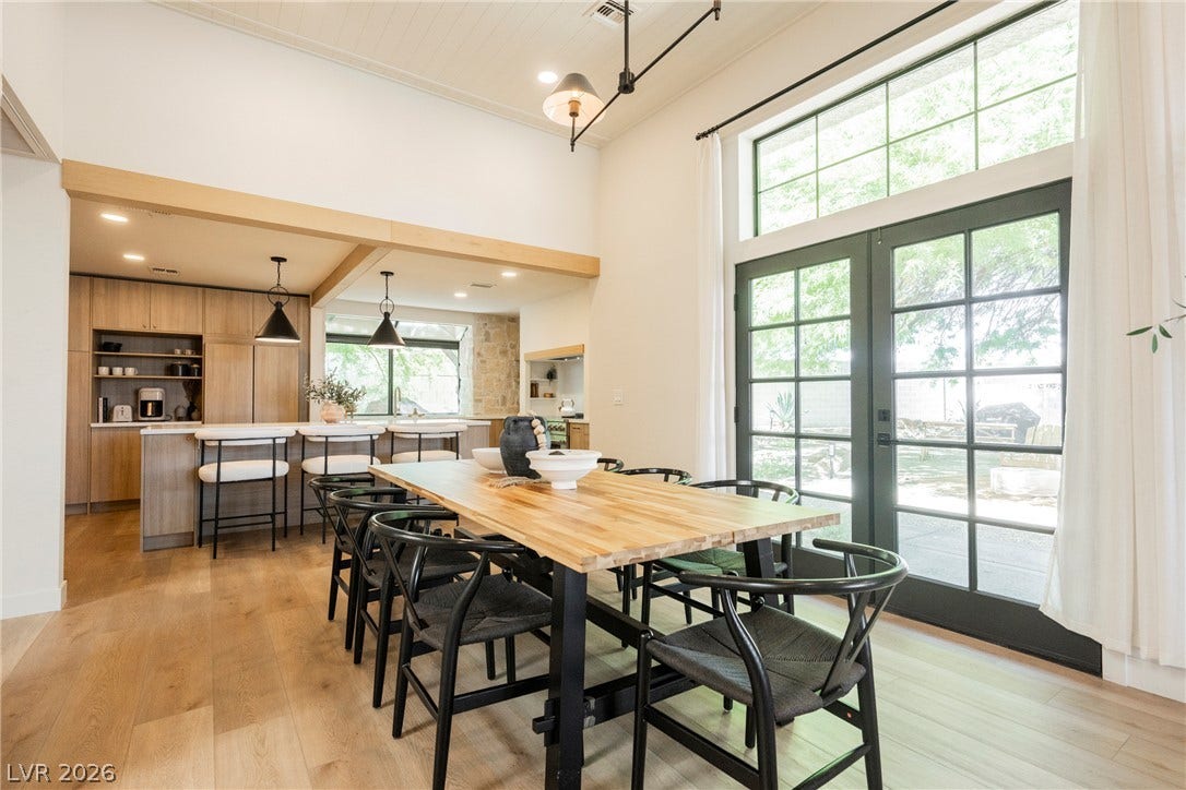 5741 S Pearl Street, Las Vegas, NV 89120 Soaring ceilings and warm wood floors anchor this open-concept dining space leading outdoors.