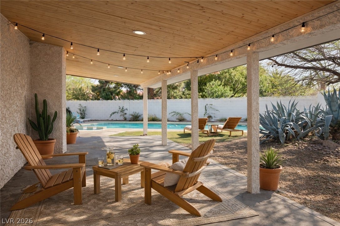 5741 S Pearl Street, Las Vegas, NV 89120 A spacious covered patio overlooks a sparkling in-ground pool and backyard desert landscaping.