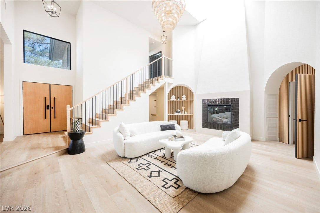 5741 S Pearl Street, Las Vegas, NV 89120 Soaring ceilings and light wood floors define this architectural living space with a custom fireplace.