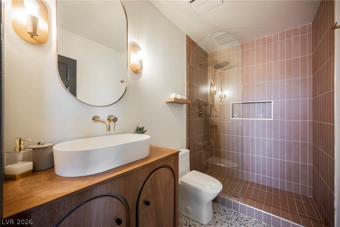 5741 S Pearl Street, Las Vegas, NV 89120 Modern finishes define this chic bathroom featuring a walk-in shower and terrazzo style flooring.