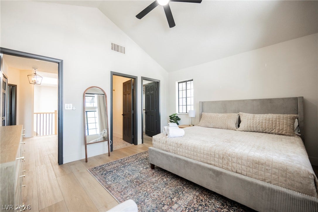 5741 S Pearl Street, Las Vegas, NV 89120 Vaulted ceilings and wide-plank wood floors define this tranquil bedroom space.