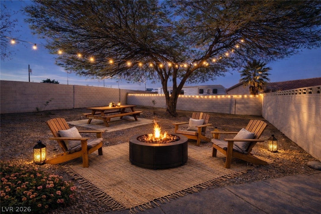5741 S Pearl Street, Las Vegas, NV 89120 A stone masonry wall encloses a spacious gravel yard with a mature shade tree.