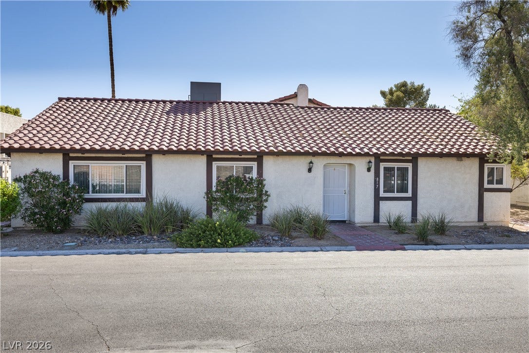 817 Spyglass Lane, Las Vegas, NV 89107 Spanish tile roofing and classic stucco define this charming single-story exterior.