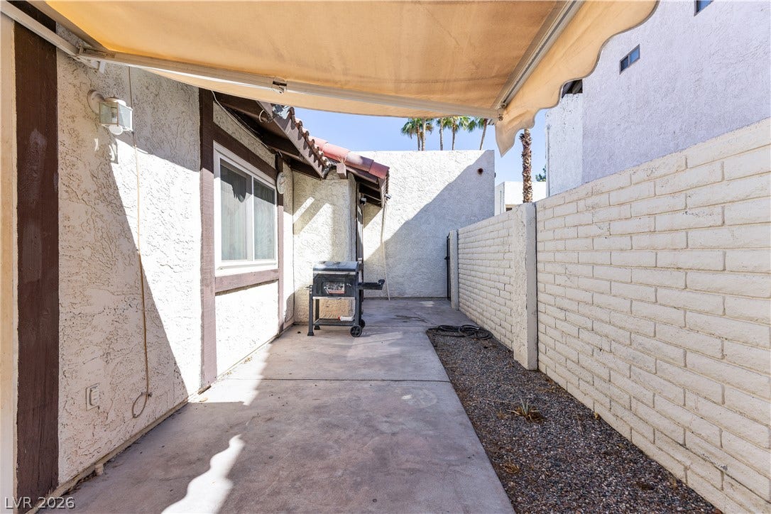 817 Spyglass Lane, Las Vegas, NV 89107 A private paved courtyard provides a functional outdoor space lined by block fencing.