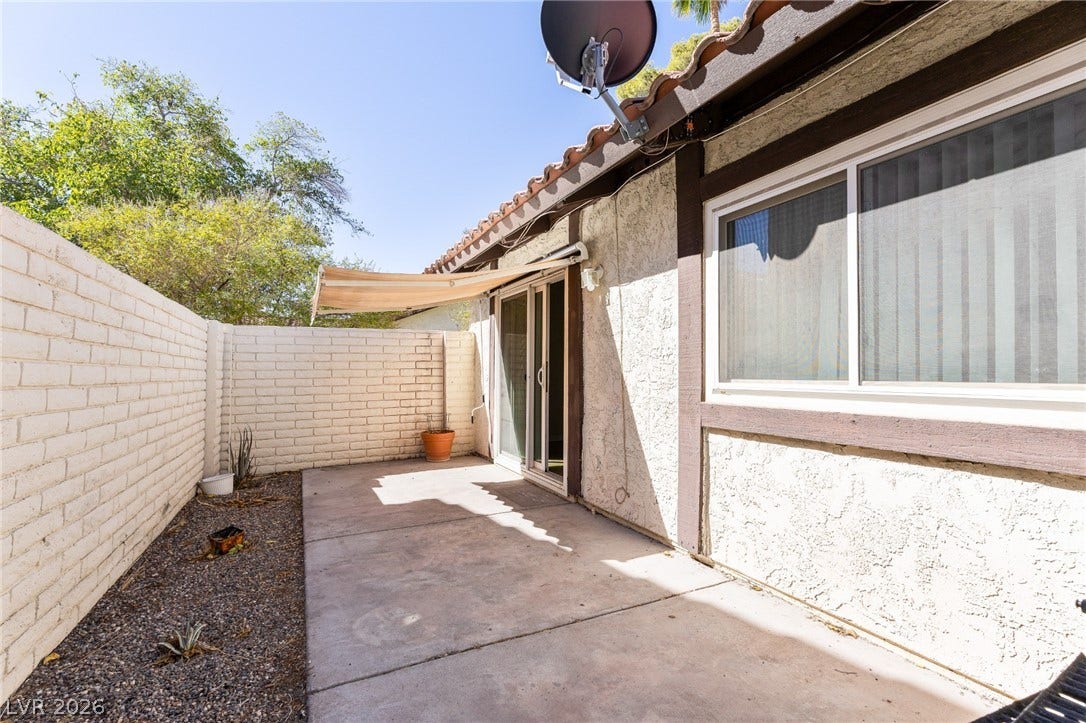 817 Spyglass Lane, Las Vegas, NV 89107 A private concrete courtyard features a retractable awning and durable stucco walls.