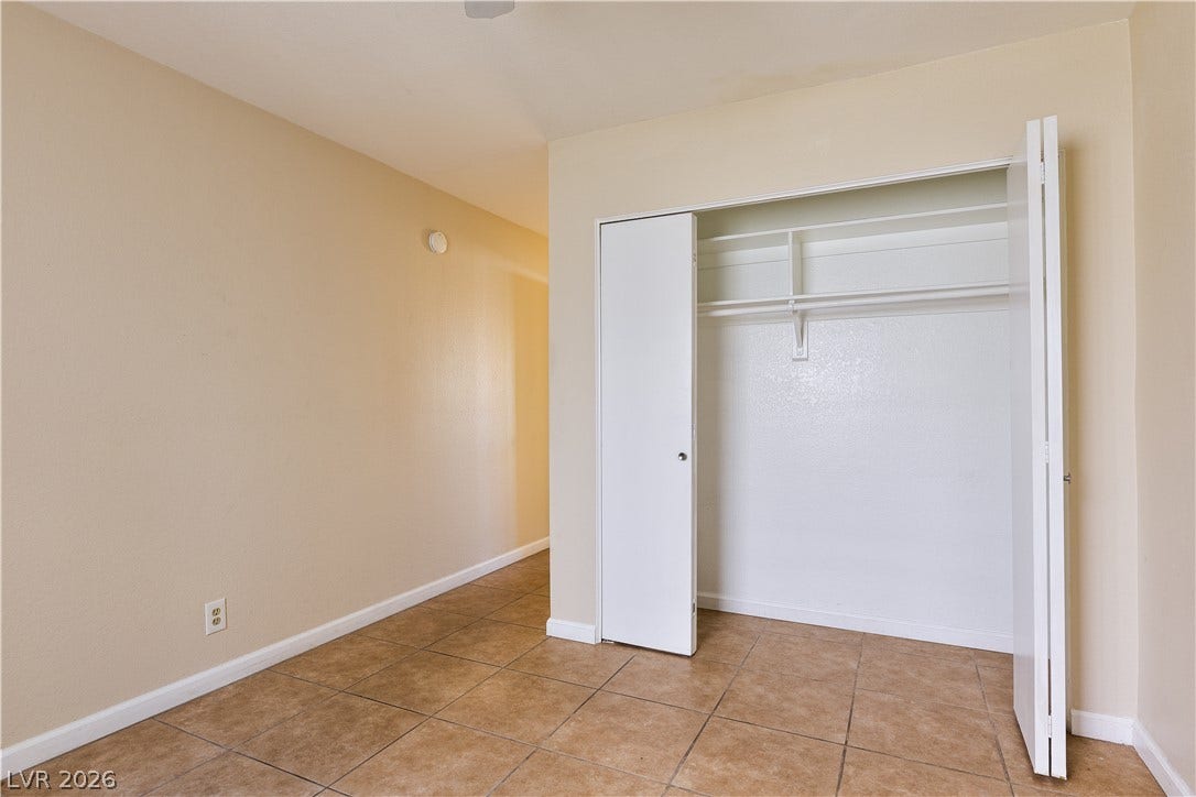 817 Spyglass Lane, Las Vegas, NV 89107 Tiled flooring and a built-in closet with integrated shelving anchor this versatile interior space.