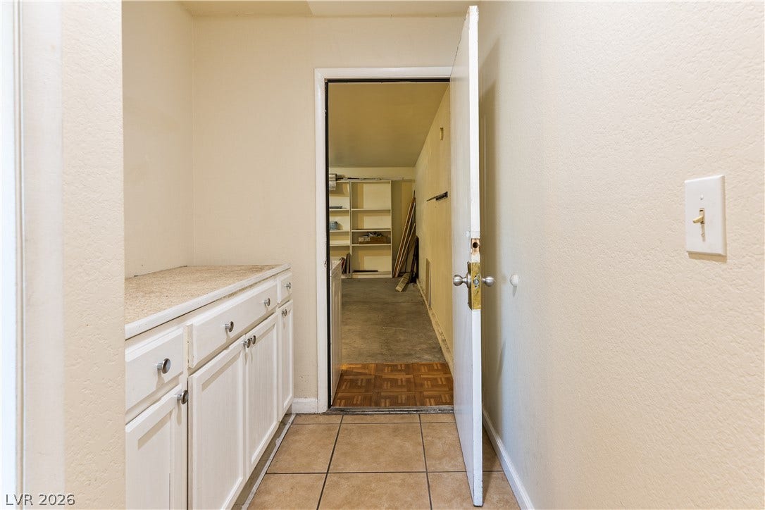 817 Spyglass Lane, Las Vegas, NV 89107 A functional utility space connects directly to a spacious garage with built-in storage shelving.