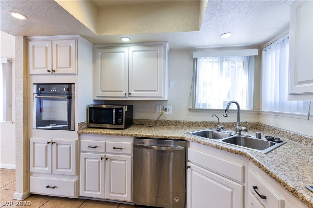 817 Spyglass Lane, Las Vegas, NV 89107 Richcountertops pair elegantly with classic raised-panel cabinetry and tile flooring.