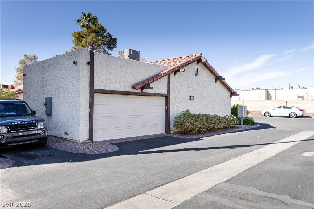 817 Spyglass Lane, Las Vegas, NV 89107 Stucco exterior elements and a tiled roof line define this modern residential structure.