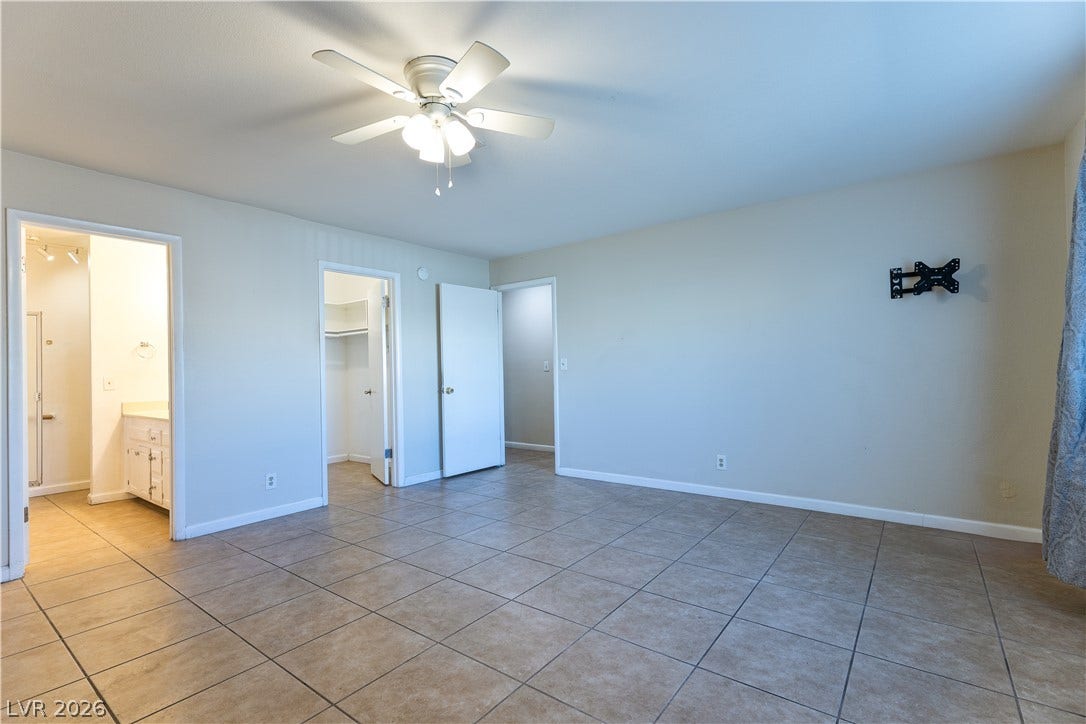817 Spyglass Lane, Las Vegas, NV 89107 Tiled flooring and neutral walls ground this versatile space leading directly to adjacent rooms.