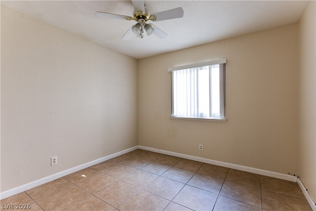 817 Spyglass Lane, Las Vegas, NV 89107 Tiled flooring and simple baseboards define this versatile auxiliary bedroom.