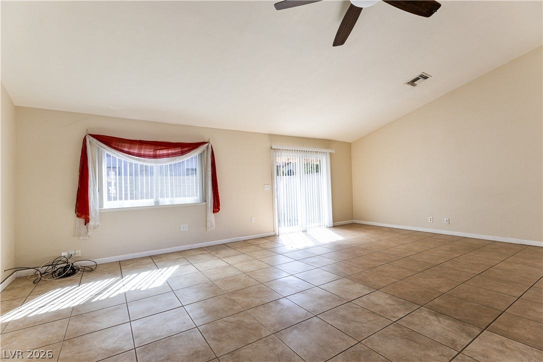 817 Spyglass Lane, Las Vegas, NV 89107 Vaulted ceilings and durable tile flooring define this spacious living area.