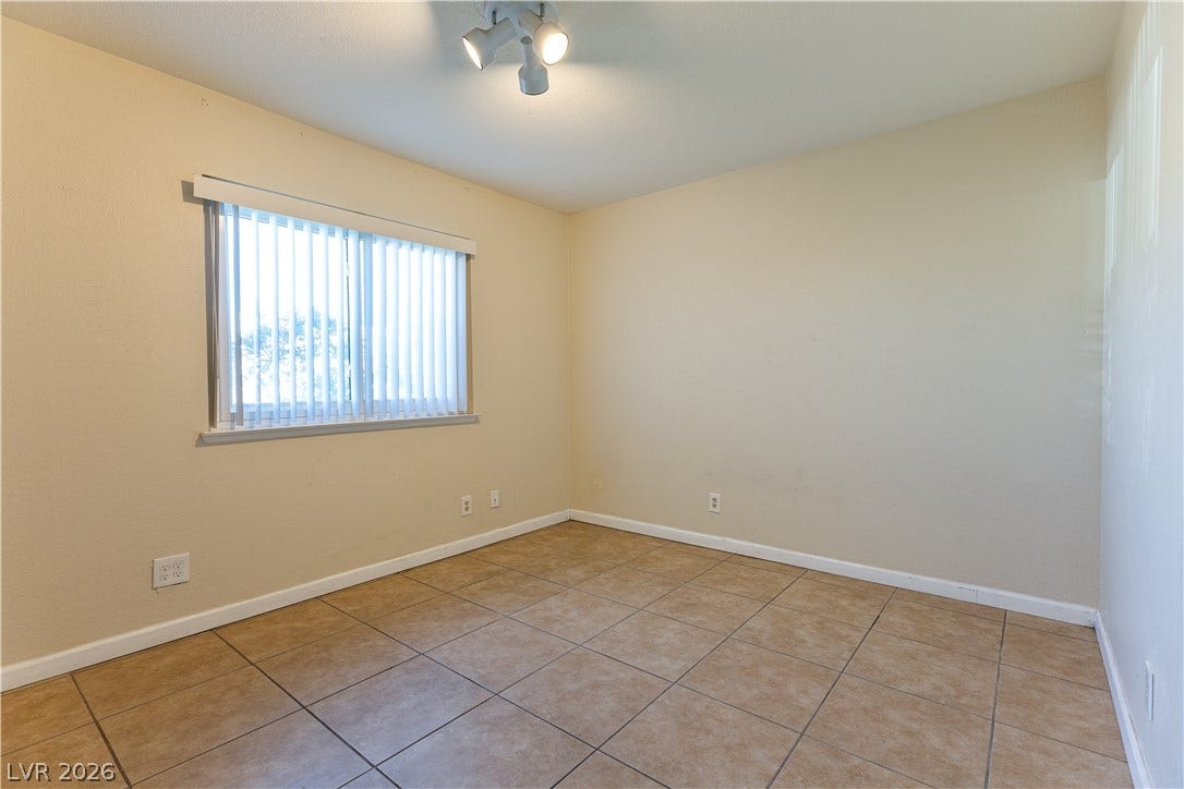 817 Spyglass Lane, Las Vegas, NV 89107 Durable tile flooring highlights this versatile bedroom space filled with soft natural light.