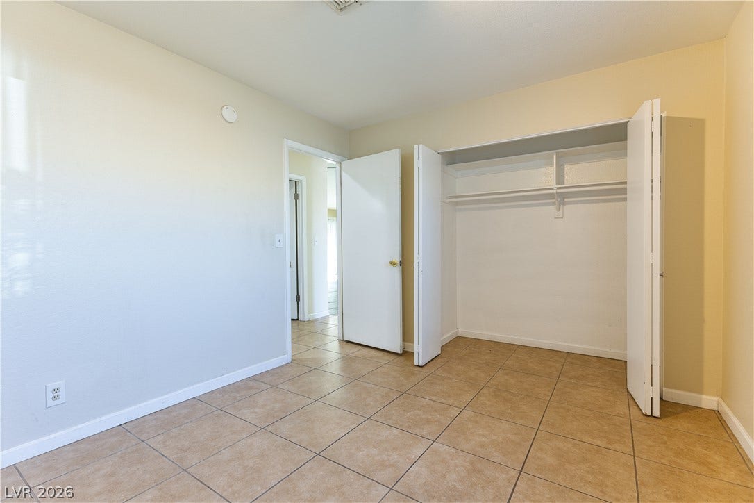 817 Spyglass Lane, Las Vegas, NV 89107 Tiled flooring and a built-in closet with folding doors define this versatile space.