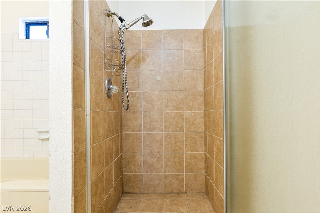817 Spyglass Lane, Las Vegas, NV 89107 Tiled walls and a glass enclosure define this functional walk-in shower stall.