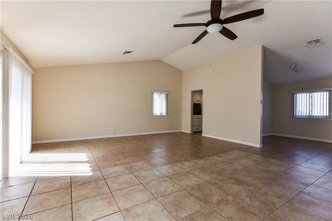 817 Spyglass Lane, Las Vegas, NV 89107 Vaulted ceilings and durable tile flooring highlight this airy, open-concept living area.