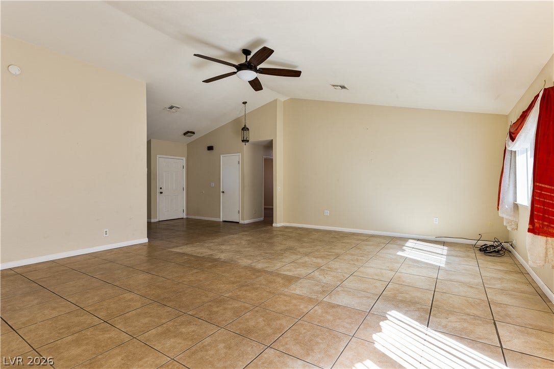 817 Spyglass Lane, Las Vegas, NV 89107 An open floorplan with durable tile flooring and soaring vaulted ceilings defines this versatile interior.