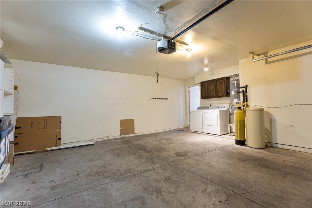 817 Spyglass Lane, Las Vegas, NV 89107 An two car attached garage provides water conditioner and concrete flooring.