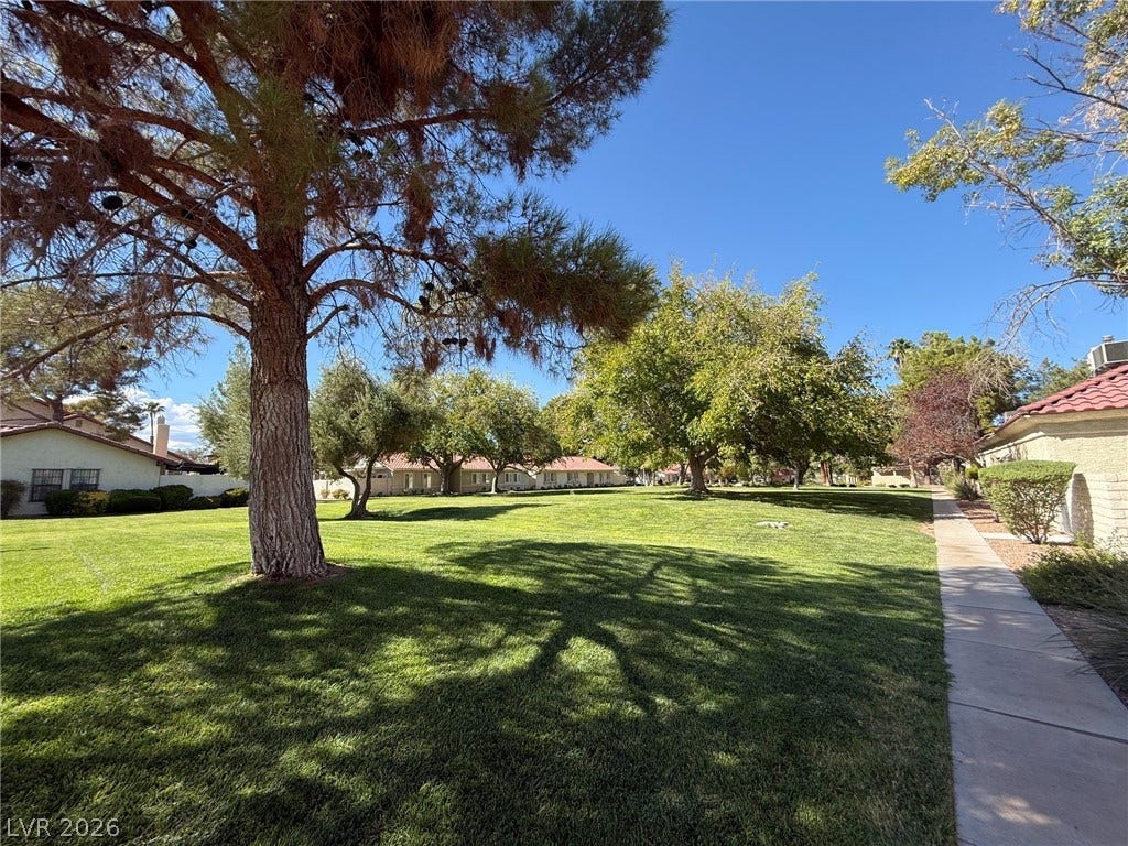 817 Spyglass Lane, Las Vegas, NV 89107 Trees shade a wide greenbelt bordered by a concrete walkway.