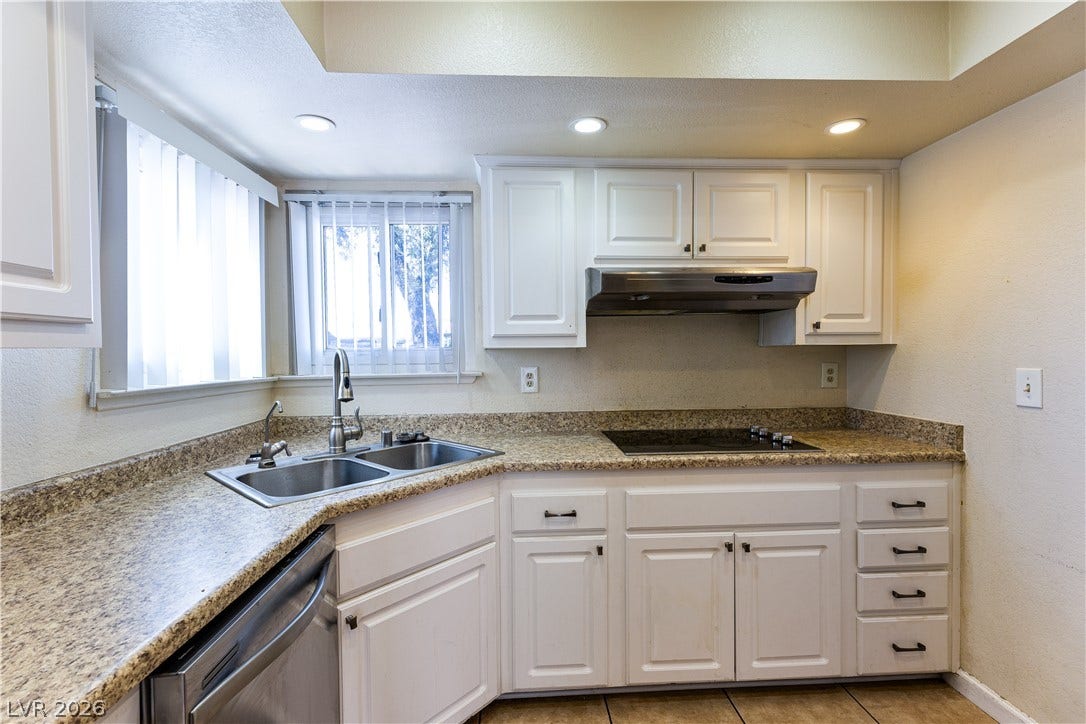 817 Spyglass Lane, Las Vegas, NV 89107 Gleaming stone countertops and classic cabinetry anchor this well-appointed kitchen space.