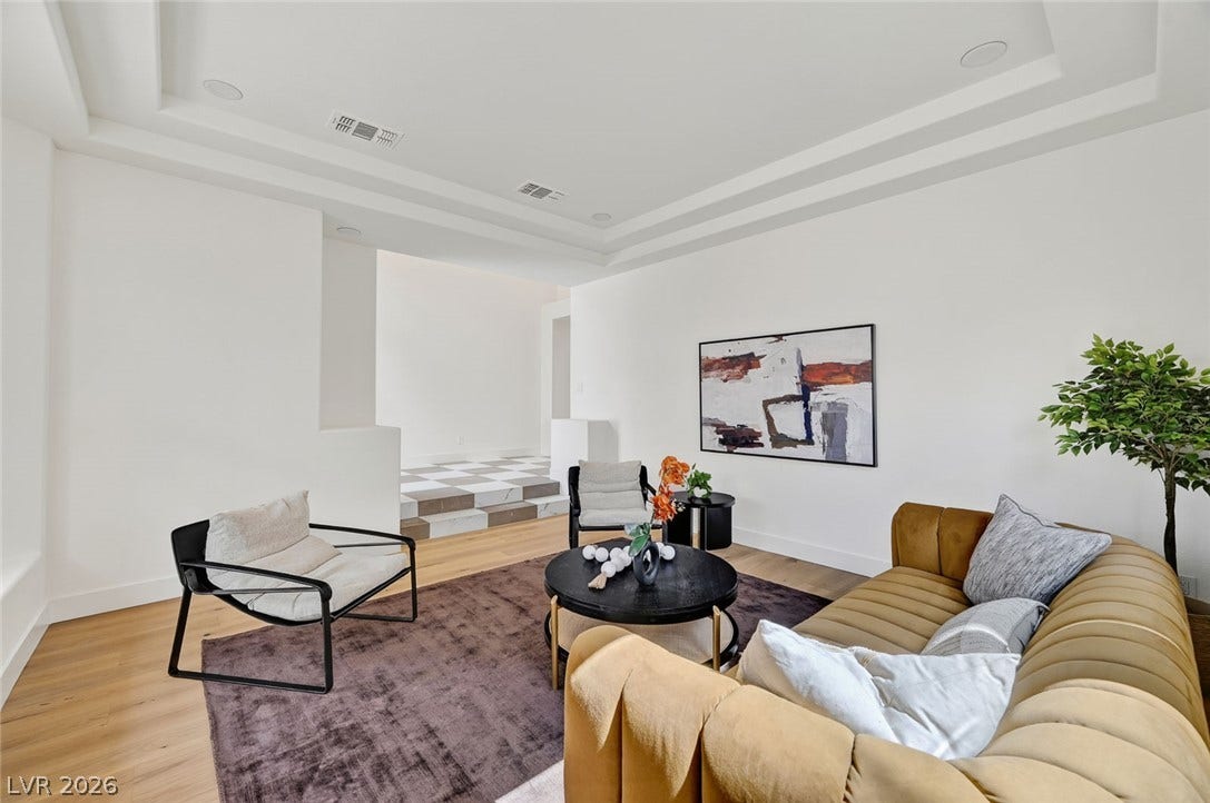 1900 Glenview Drive, Las Vegas, NV 89134 Elegant recessed lighting and a tray ceiling frame this spacious living area with hardwood floors.
