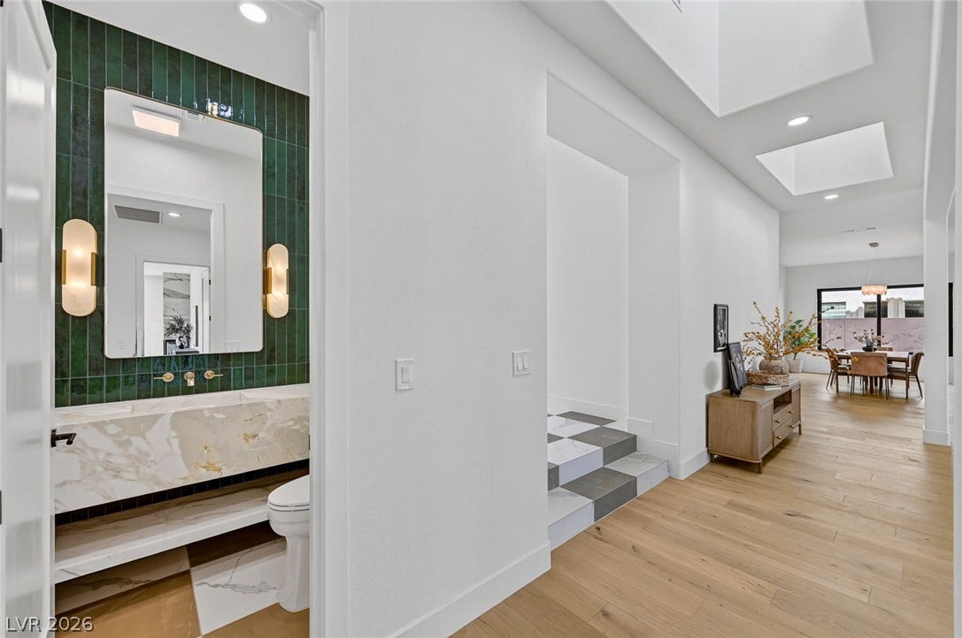 1900 Glenview Drive, Las Vegas, NV 89134 A light-filled hallway flows seamlessly past a modern powder room toward the main living spaces.