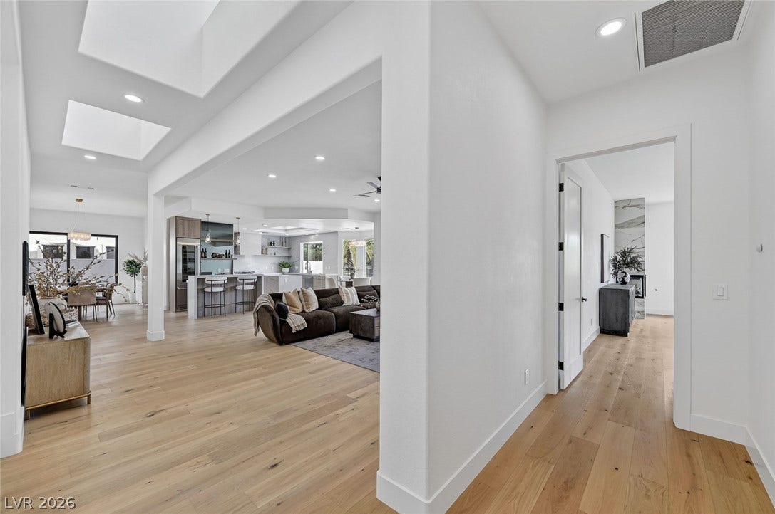 1900 Glenview Drive, Las Vegas, NV 89134 Smooth plaster archways and light oak flooring connect the open living spaces.