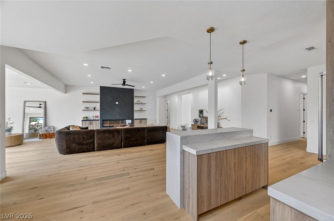 1900 Glenview Drive, Las Vegas, NV 89134 Clean lines and wide-plank wood floors define this expansive open-concept living space.