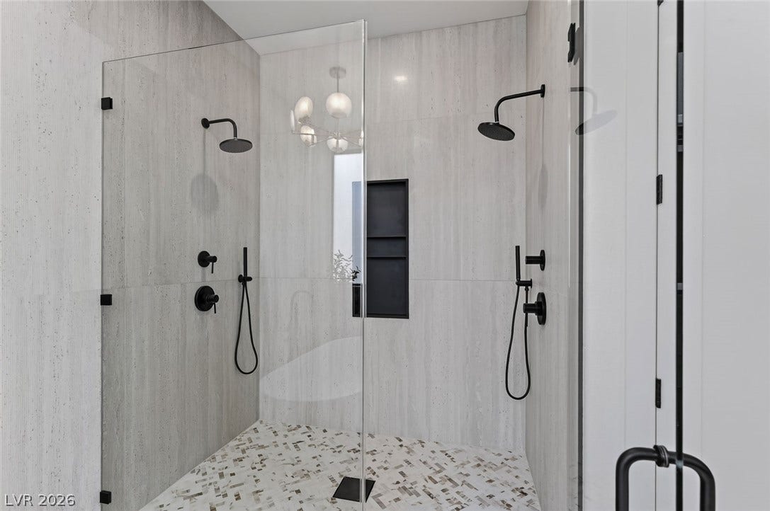 1900 Glenview Drive, Las Vegas, NV 89134 A spacious walk-in shower features dual showerheads and elegant tile surrounds.