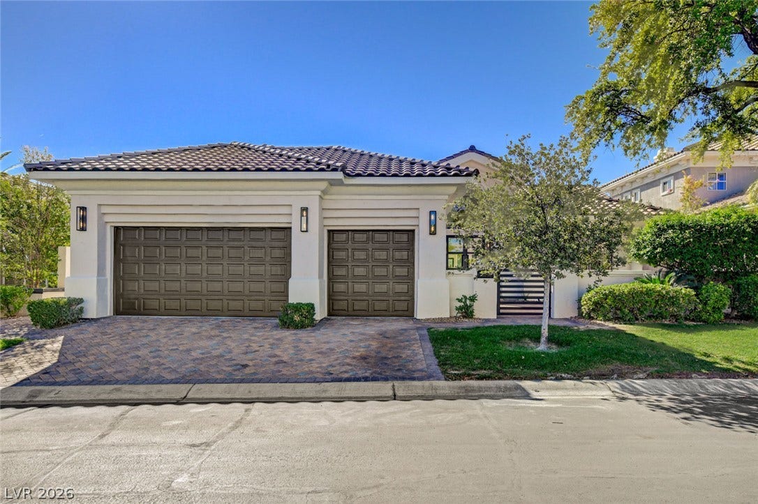 1900 Glenview Drive, Las Vegas, NV 89134 Spanish tile roofing and a paved driveway enhance this stucco home with a three-car garage.