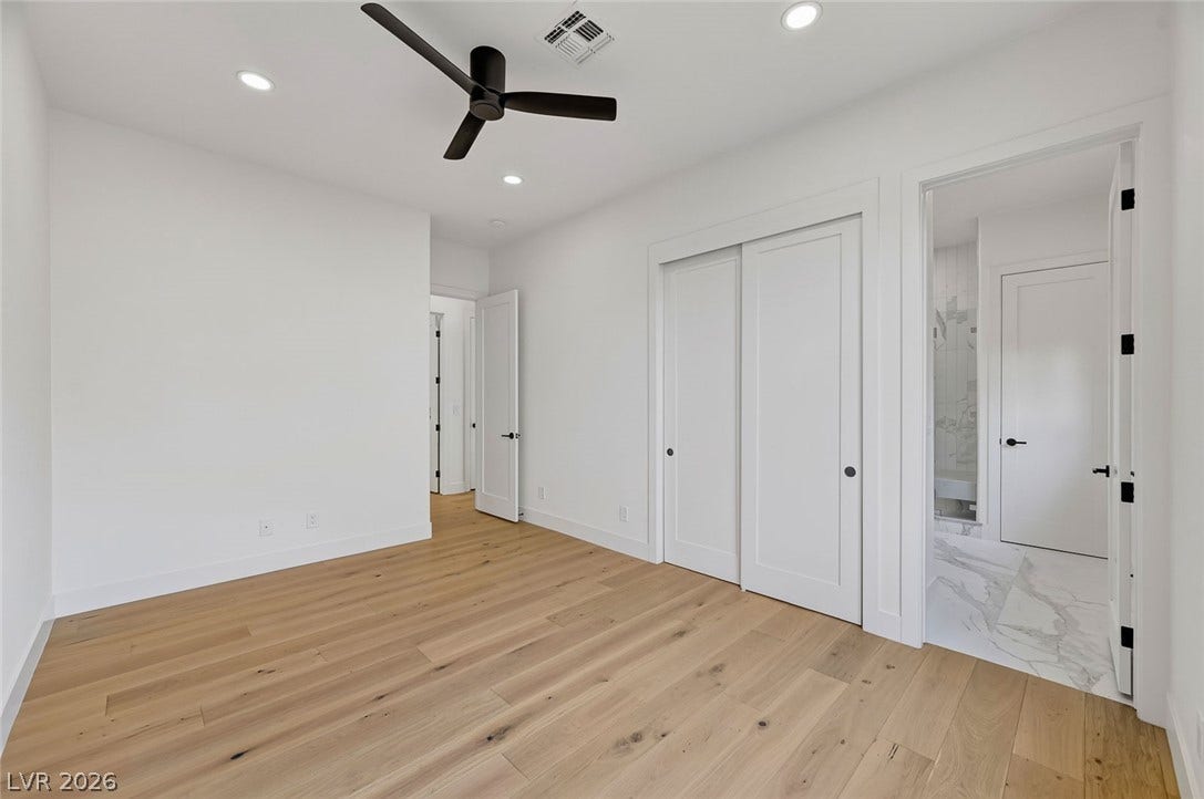 1900 Glenview Drive, Las Vegas, NV 89134 Smooth plaster walls and warm hardwood floors create a clean canvas for this bedroom.