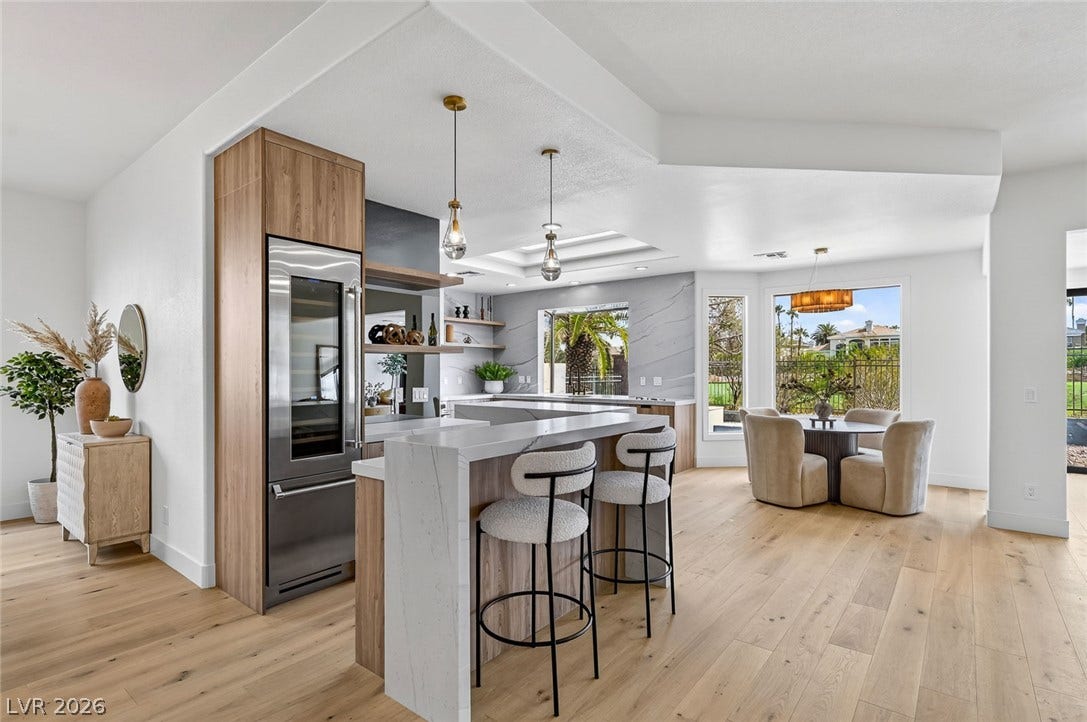 1900 Glenview Drive, Las Vegas, NV 89134 Gleaming hardwood floors and a spacious waterfall island anchor this open-concept kitchen and dining area.