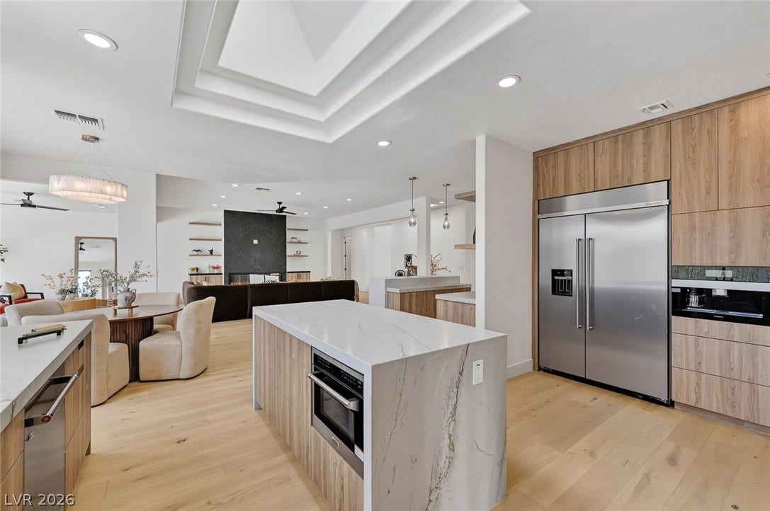 1900 Glenview Drive, Las Vegas, NV 89134 An open kitchen showcases sleek modern cabinetry, quartz countertops, and warm hardwood floors.