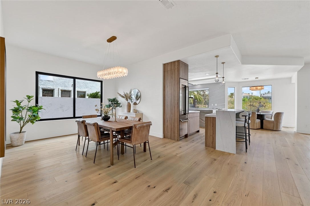 1900 Glenview Drive, Las Vegas, NV 89134 Hardwood floors and crisp white walls flow seamlessly from the dining space into the kitchen.