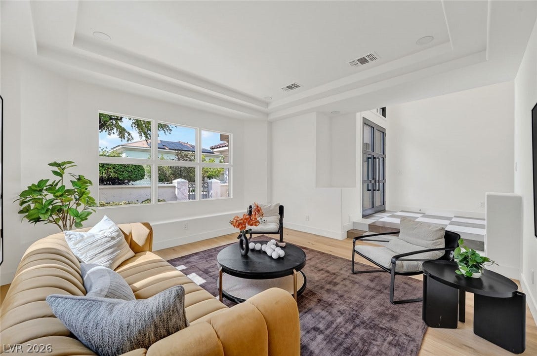 1900 Glenview Drive, Las Vegas, NV 89134 Gleaming hardwood floors and a tiered tray ceiling define this open, light-filled sitting area.