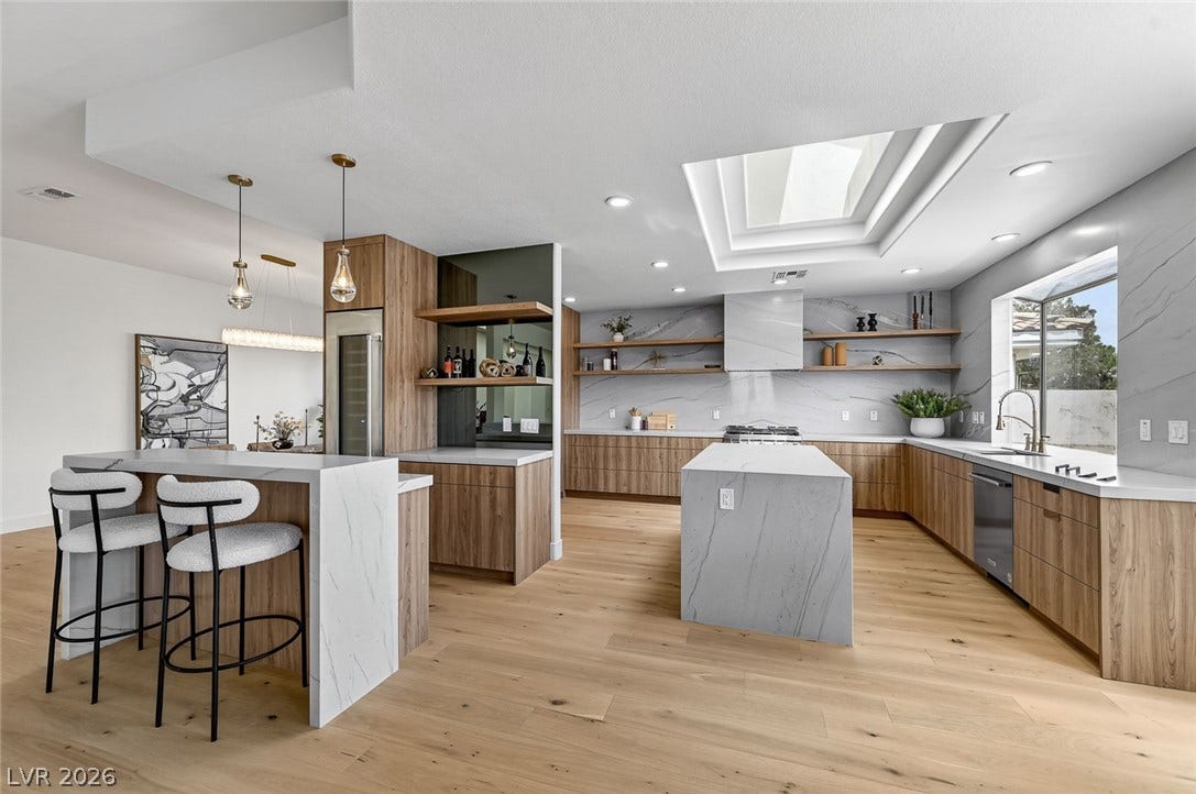 1900 Glenview Drive, Las Vegas, NV 89134 A skylight illuminates the natural wood cabinetry and stone countertops of this open kitchen.