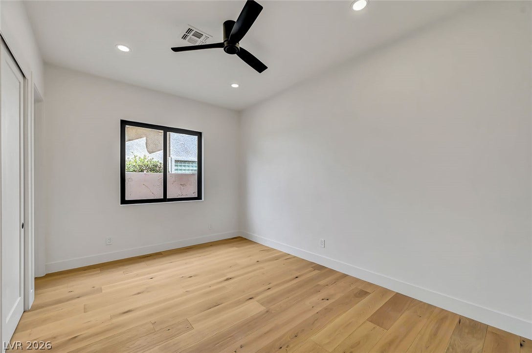 1900 Glenview Drive, Las Vegas, NV 89134 Warm wood flooring and clean white walls create a minimalist backdrop in this serene space.