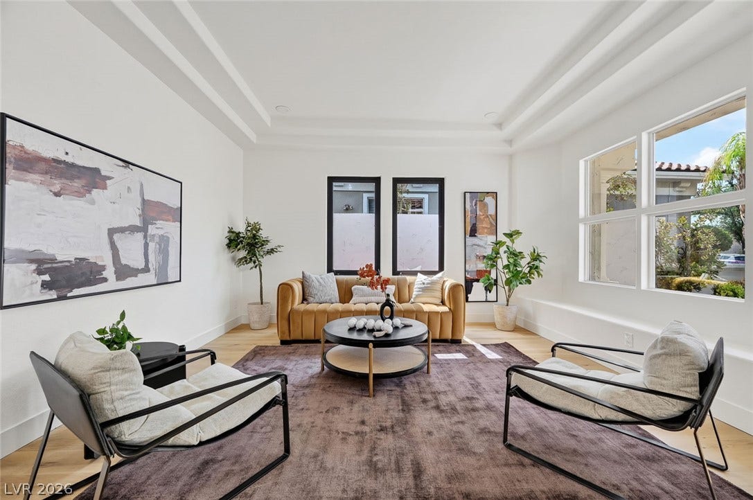 1900 Glenview Drive, Las Vegas, NV 89134 Multi-tiered tray ceilings and light wood floors elevate this welcoming living space.