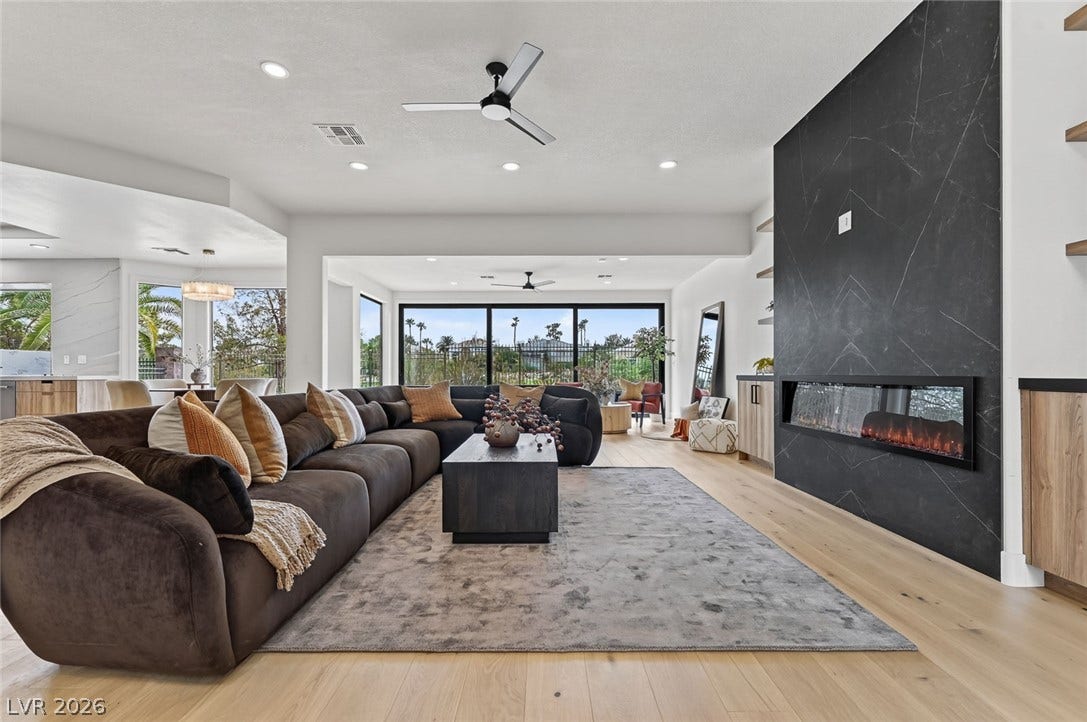 1900 Glenview Drive, Las Vegas, NV 89134 Rich wood floors and a contemporary linear fireplace define this airy open-concept living space.