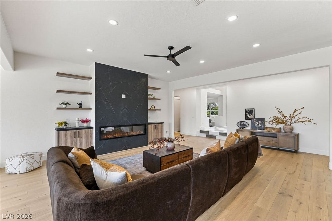 1900 Glenview Drive, Las Vegas, NV 89134 Elegant wood floors anchor this open living area featuring a modern linear fireplace.