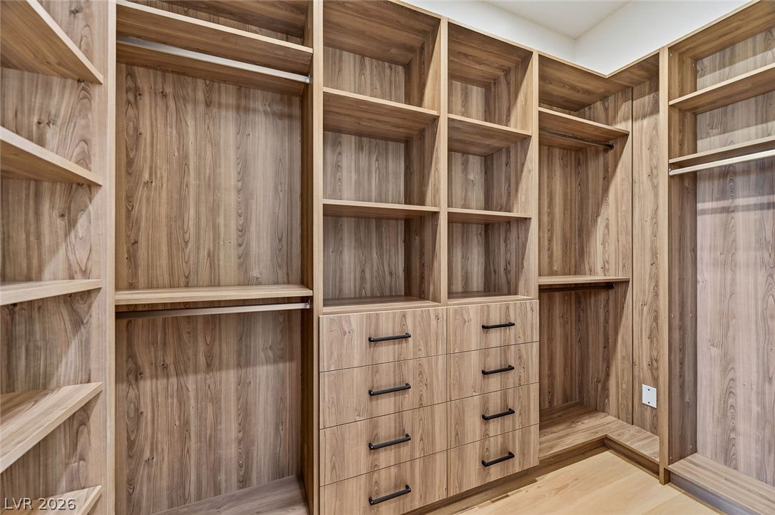1900 Glenview Drive, Las Vegas, NV 89134 Custom wood shelving and built-in drawers maximize storage space in this master closet.