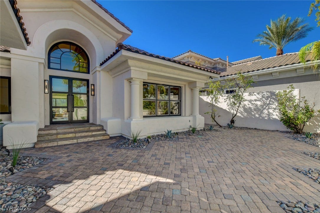 1900 Glenview Drive, Las Vegas, NV 89134 An arched portico and paved courtyard create a grand entryway to this elegant residence.