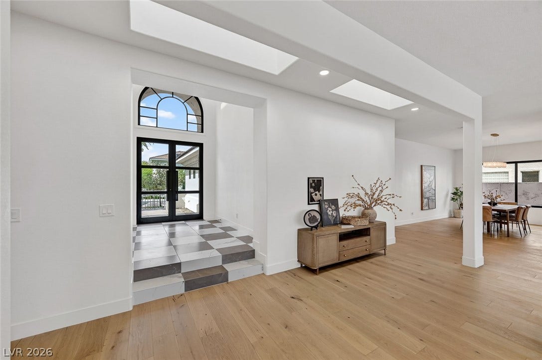 1900 Glenview Drive, Las Vegas, NV 89134 Natural light streams through high ceilings and prominent skylights over beautiful hardwood flooring.