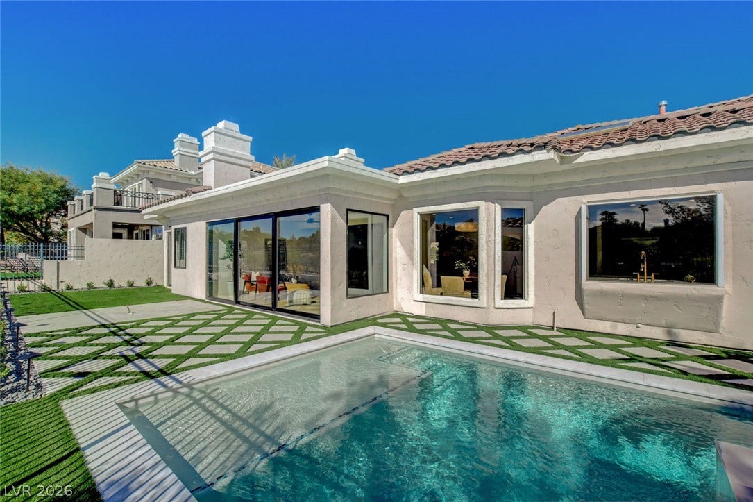 1900 Glenview Drive, Las Vegas, NV 89134 Geometric pavers surround a sparkling backyard pool adjacent to the stucco home exterior.