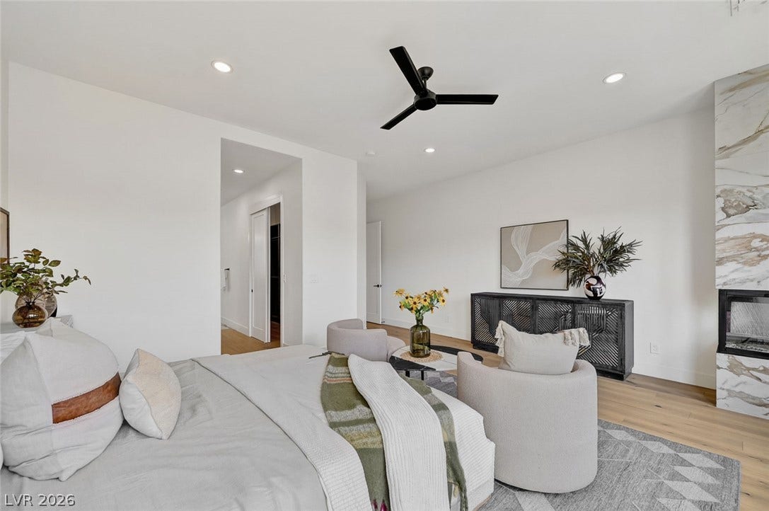 1900 Glenview Drive, Las Vegas, NV 89134 Gleaming hardwood floors and a modern stone fireplace anchor this airy principal suite.